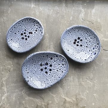 three blue speckled soap dishes