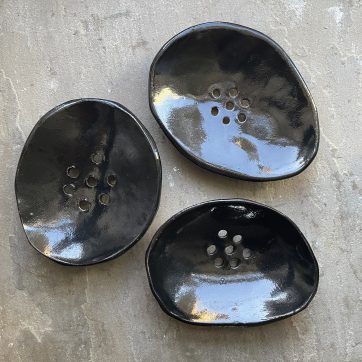 Three black ceramic soap dishes
